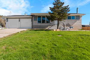 View of front of property featuring concrete driveway, an attached garage, and brick siding