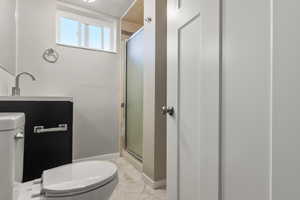 Full bathroom with a shower stall, light marble finish flooring, and vanity