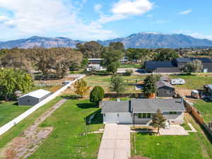 Drone / aerial view of the front of the subject property. Barn and shop located in the backyard, accessed by side driveway.