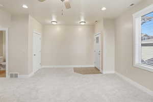 Unfurnished room with light colored carpet, recessed lighting, and a ceiling fan