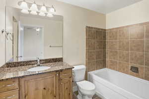 Bathroom with vanity, shower / bathtub combination, and tile patterned flooring