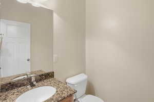 Bathroom featuring vanity and toilet