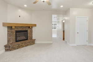 Unfurnished living room with carpet flooring, recessed lighting, a ceiling fan, and a fireplace