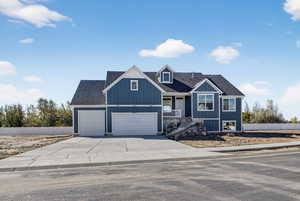 View of front of property with driveway and roof with shingles