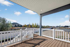 Wooden deck featuring a residential view and a fenced backyard
