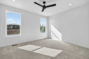 Unfurnished room featuring carpet, recessed lighting, and a ceiling fan