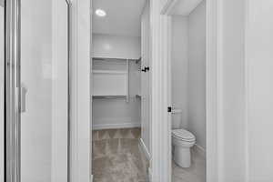 Full bath featuring a spacious closet and a stall shower