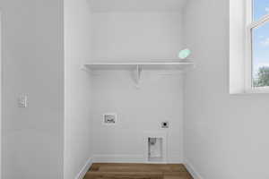 Laundry room featuring wood finished floors, electric dryer hookup, and hookup for a washing machine