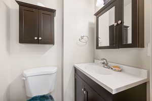 Half bath with vanity and toilet