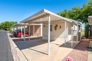 View of vehicle parking featuring an attached carport