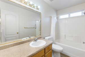 Full bathroom featuring shower / bathtub combination with curtain and vanity