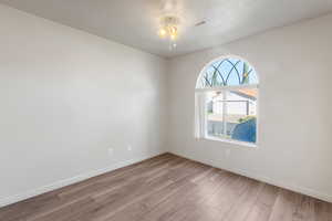 Spare room featuring light wood-style floors and a ceiling fan