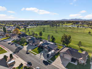 Aerial perspective of suburban area featuring a water and mountain view and a golf club