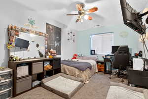 Bedroom with carpet floors, ceiling fan, an office area, and a textured ceiling