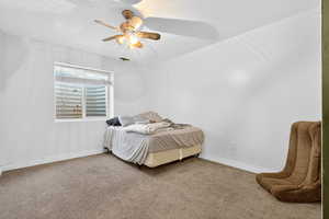 Bedroom with carpet, a ceiling fan, and a textured ceiling
