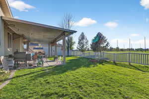 Fenced backyard with a patio
