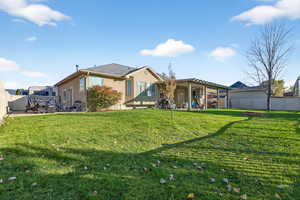 Back of house with a fenced backyard, a patio area, and stucco siding