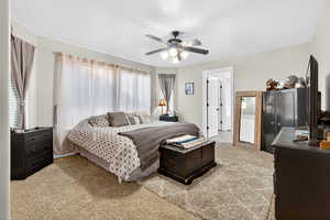 Bedroom featuring light colored carpet and ceiling fan