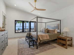 Bedroom with light colored carpet, a ceiling fan, recessed lighting, and vaulted ceiling