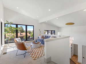 Living room featuring beamed ceiling, recessed lighting, high vaulted ceiling, and light colored carpet