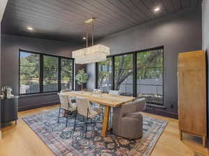 Dining room featuring wooden ceiling, light wood-type flooring, recessed lighting, and a chandelier