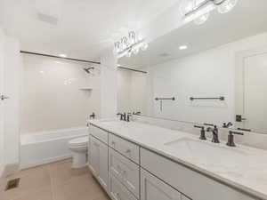 Full bathroom featuring tub / shower combination, light tile patterned flooring, double vanity, and recessed lighting