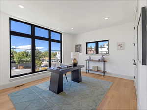 Office space with recessed lighting and light wood-type flooring
