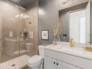 Full bathroom with vanity and a shower stall