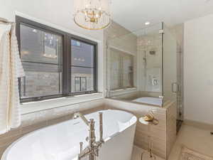 Full bath featuring a soaking tub, a shower stall, tile patterned floors, a chandelier, and recessed lighting