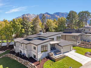 Aerial view of property and surrounding area featuring mountains