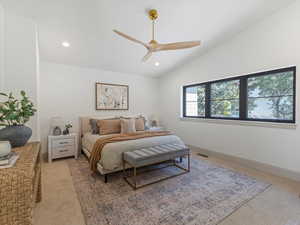 Bedroom with light colored carpet, vaulted ceiling, recessed lighting, and ceiling fan