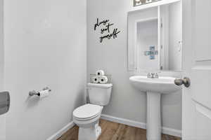 Bathroom with wood finished floors and baseboards