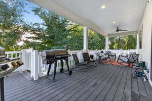 Wooden deck featuring area for grilling and a ceiling fan
