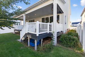View of property exterior featuring a fenced backyard, a deck, and stucco siding