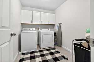 Washroom with washer and dryer and cabinet space