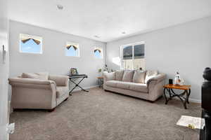Carpeted living area with baseboards