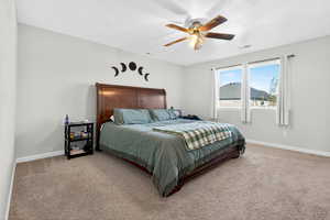 Bedroom with light carpet and a ceiling fan