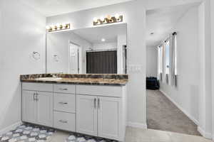 Full bathroom with light colored carpet, double vanity, light tile patterned floors, and curtained shower