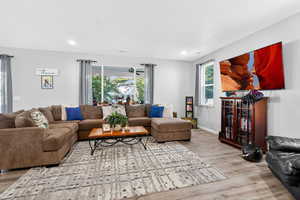 Living room featuring light wood-style flooring and recessed lighting