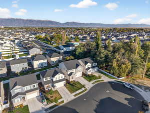 Aerial view of property's location with a mountainous background and nearby suburban area