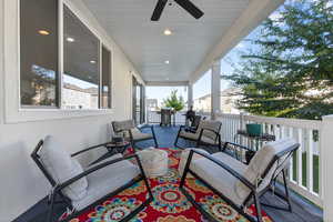 Wooden terrace featuring ceiling fan, outdoor lounge area, and area for grilling