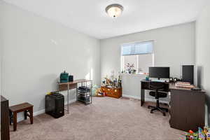 Office area with light colored carpet and baseboards