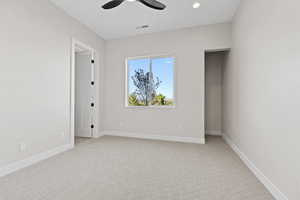 Unfurnished room with light colored carpet, a ceiling fan, and recessed lighting