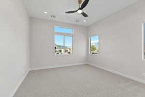 Unfurnished room featuring light colored carpet, ceiling fan, and recessed lighting