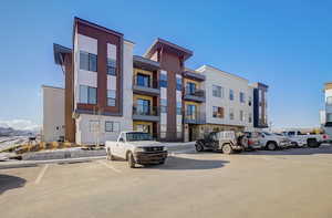 View of property featuring parking