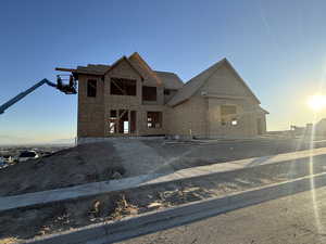 View of front of home with roof with shingles