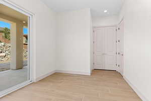 Empty room featuring wood tiled floors and recessed lighting