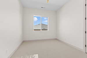 Carpeted empty room with baseboards
