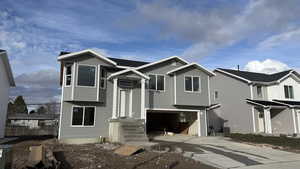 View of front of home featuring an attached garage and concrete driveway