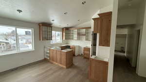 Kitchen featuring a peninsula, dark wood-style flooring, and tile counters